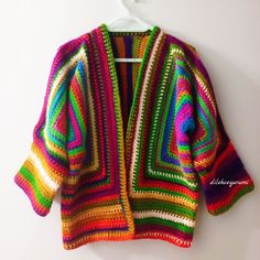 Rainbow hand-knit cardigan. It is completely hand knitted. knitted. Cozy Multicolor Cardigan With Fair Isle Pattern, Cozy Multicolor Fair Isle Cardigan, Colorful Bohemian Knitted Cardigan, Bohemian Knitting Patterns With Yarn, Bohemian Hand Knitted Sweater Coat, Colorful Hand Knitted Bohemian Sweater, Hand Knitted Bohemian Yarn Cardigan, Bohemian Hand Knitted Yarn Cardigan, Bohemian Hand Knitted Patterns For Fall