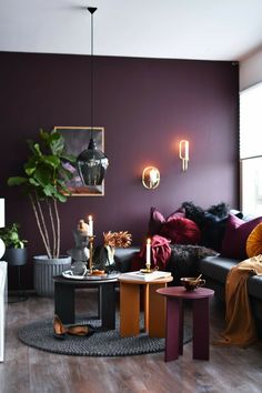 a living room with purple walls and furniture