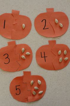 four pumpkins cut out with numbers on them