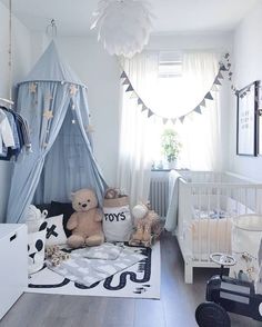 a baby's room with a bed, crib and other items in it