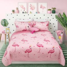 a pink bed with flamingos on it