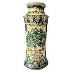 an ornate vase is painted with blue and green designs on it's sides,