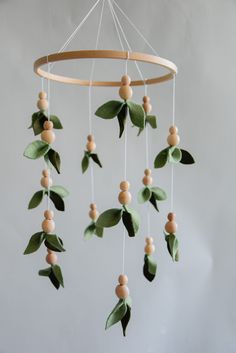 a mobile with leaves and berries hanging from it