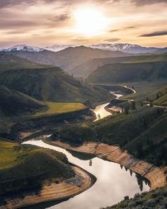 a river running through a lush green valley