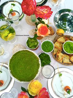 a table is set with plates and bowls filled with food