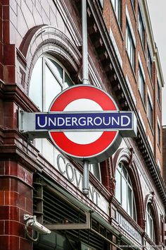 an underground sign on the side of a building