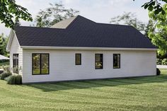 a small white house sitting on top of a lush green field