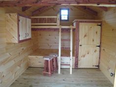 the inside of a small cabin with wooden walls