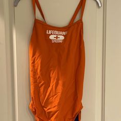 New Orange And Blue Speedo Lifeguard Bathing Suit. Size 12/38 Fitted Orange Swimsuit For Swimming, Orange Fitted One Piece For Swimming, Fitted Orange One Piece For Swimming, Fitted Orange One-piece Swimsuit, Summer Orange Swimming One-piece, Orange Sleeveless One Piece For Pool, Sleeveless Orange One Piece For Pool, Sleeveless Orange One-piece For Poolside, Orange Sleeveless Summer One Piece