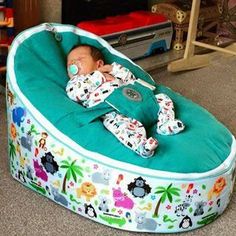 a baby laying in a bean bag chair