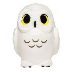 a white owl with yellow eyes is standing