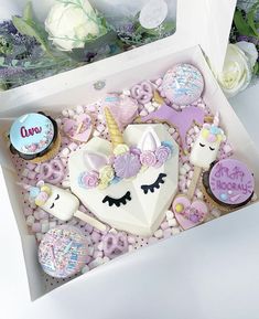 a box filled with lots of decorated cookies