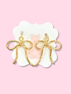 Evie Gold Bow Earrings | Sassy Shortcake |sassyshortcake.com Gold Dainty Bow Earrings, Gold Dainty Earrings With Bow, Dainty Gold Earrings With Bow, Elegant Rose Gold Bow Earrings, Elegant Rose Gold Earrings With Bow, Dainty Gold Bow Earrings, Chic Gold Earrings With Decorative Bow, Gold Ribbon Earrings For Party, Gold Earrings With Decorative Bow For Formal Occasions