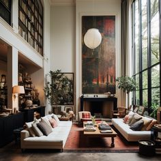 a living room filled with lots of furniture next to large windows and a painting on the wall