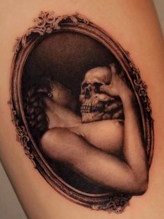 a woman's arm with a skull in the shape of a frame on it