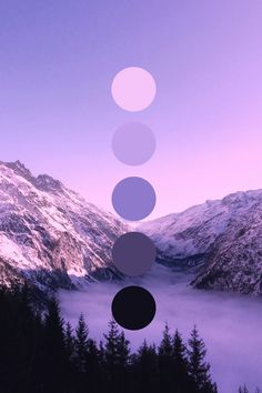 an abstract photo with five circles in front of snow covered mountains and foggy water