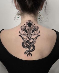 a woman with a black and white tattoo on her back