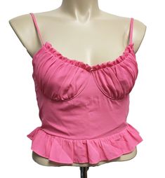 superdown Cadence Ruffle Cami Top in Hot Pink. 100% poly. Hand wash cold. Hidden side zipper closure. Adjustable shoulder straps. Underwire cups. Smocked back. Ruffle hem. Bust seams reignforced with red thread - not noticeable while wearing. Minor fabric discoloration at middle front. Please see photos. Fitted Tops With Built-in Bra And Ruffled Straps, Trendy Ruffled Tank Top For Party, Trendy Party Tank Top With Ruffles, Fitted Ruffle Cami Crop Top, Flirty Top With Adjustable Ruffled Straps, Stretch Sleeveless Lined Tops, Sleeveless Smocked Bodice Top For Party, Sleeveless Smocked Bodice Party Top, Fitted Ruched Top With Ruffled Straps