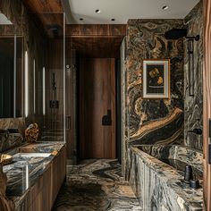 a bathroom with marble counter tops and wooden walls