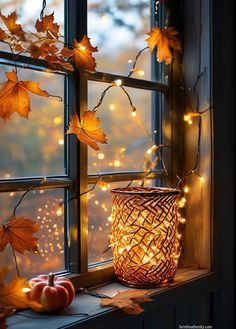 a window sill filled with autumn leaves and lights