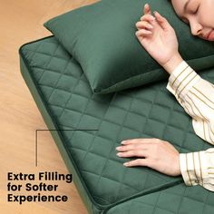 a woman laying on top of a green couch next to pillows with the words extra filling for softer experience