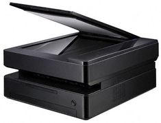 an open laptop computer sitting on top of a printer tray in front of a white background