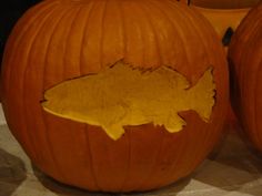 two carved pumpkins with fish on them