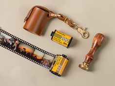 an old camera and some other items are on the table next to a film strip