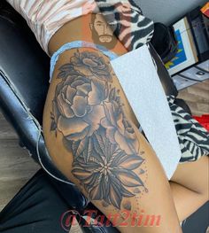 a woman's thigh with flowers on it