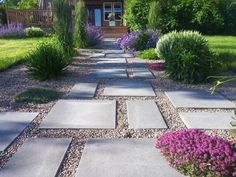 a stone walkway in front of a house