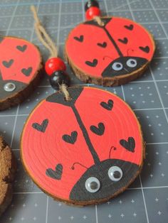 three wooden slices with painted ladybugs on them