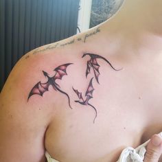 a woman with a tattoo on her chest has three bats in the shape of hearts