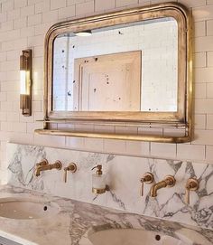 a bathroom vanity with two sinks and a large mirror