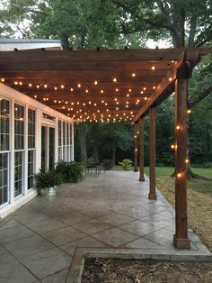 an outdoor covered patio with string lights