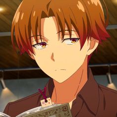 an anime character with red hair holding a book in his hand and looking at the camera