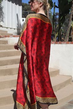 Wow them in this  striking red tunic/kaftan, so elegant with its exotic, gold animal print border, capturing the beautiful, subtle  print inside.  It is truly a traffic stopper.  The elegant, silky poly fabric just glows.  It is not sheer. Wonderful for travel, arrives wrinkle free. One size.  Fits many sizes small to large.  The width is 43 inches, edge to edge, or 86 around the body.  The length is 45 inches. The side seams are 5 inches from the edge which gives 66 inches for body room and ele Elegant Red Festival Kaftan, Elegant Red Kaftan For Festival, Red Tunic, Gold Animals, Cruise Wear, Fabric Tags, Caftan Dress, Wrinkle Free, Resort Wear