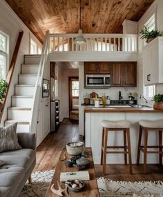 a living room filled with furniture next to a kitchen and dining area in a home