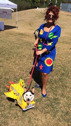 a woman is walking her dog on a leash