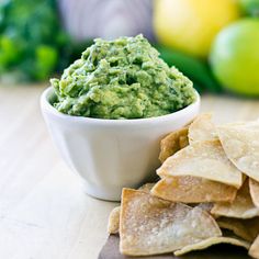 a bowl of guacamole and tortilla chips on a table