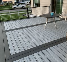 a table and chairs on a wooden deck