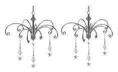 two metal chandeliers with stars hanging from them