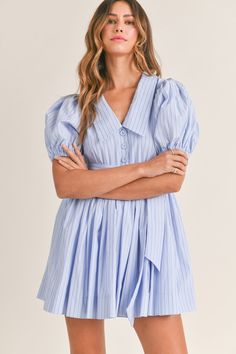 Add a touch of sophistication to your wardrobe with this Pinstripe dress. The short puff sleeves and v-neck collar create a classic look, while the self-tie and button front add unique details. Lined for comfort and in a beautiful blue color, this dress is perfect for any occasion. Bach Brunch, Farewell Brunch, Gameday Fits, Label Ideas, College Fits, Pinstripe Dress, Church Dresses, Grad Dresses, Church Outfits