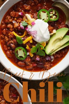 a bowl of chili with sour cream and avocado on top, along with the words hearty bean chili