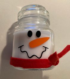 a glass jar with a snowman face on it