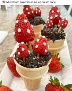 three ice cream cones topped with strawberries and mushrooms