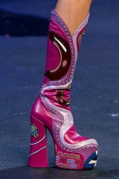 a woman's pink high heeled boots with designs on them