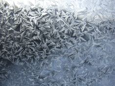 the frosty window is covered with small snowflakes