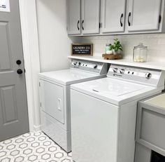 a white washer and dryer sitting next to each other in a laundry room