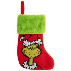 a christmas stocking with the grin on it's side and green fuzzy trim