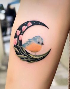 a small bird sitting on top of a crescent with flowers in the moon behind it